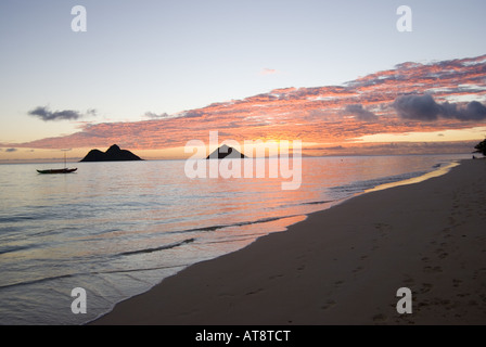 Sunrise over the Mokulua islands off Lanikai beach, called the most beautiful beach in the world. Stock Photo