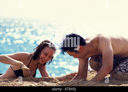 Young couple having fun at the beach, Mahaka, Oahu Stock Photo