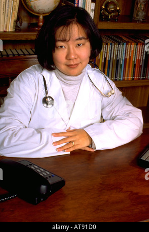 Korean American physician doctor medic age 29 working at desk. St Paul Minnesota MN USA Stock Photo