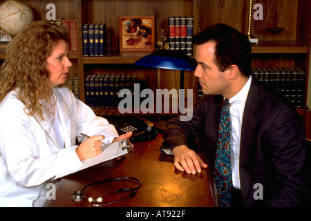 Woman doctor working with Argentinean Hispanic patient ages 32 and 33. St Paul Minnesota MN USA Stock Photo