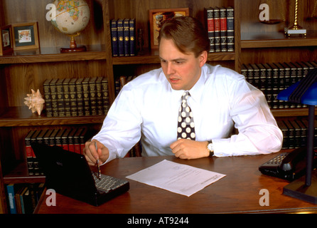 Lawyer age 27 working on laptop computer in office. St Paul Minnesota MN USA Stock Photo