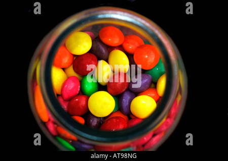 A Glass Jar Filled With Multi Coloured Sweets/Candy.