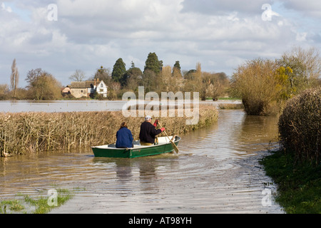 Local residents travelling by boat in a flooded lane near the River Severn at Deerhurst, Gloucestershire UK in March 2007 Stock Photo