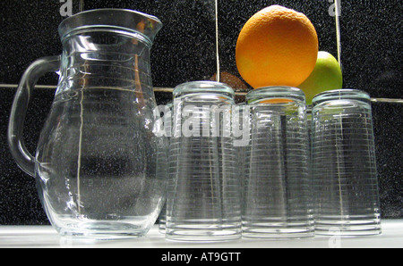 Still life with glass jug tumblers and fruit Stock Photo