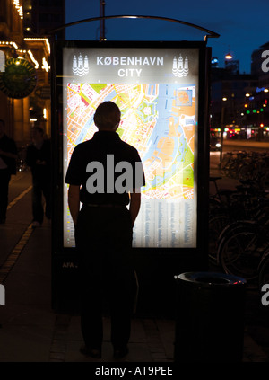 Copenhagen Denmark Silhouette of tourist examining city map Stock Photo