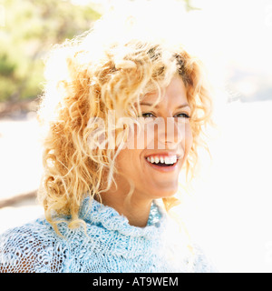 Close up portrait of attractive young blond woman smiling Stock Photo