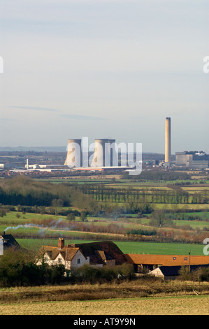 Didcot Power Station, Oxfordshire, with smoke coming from a domestic chimney in the foreground. Stock Photo