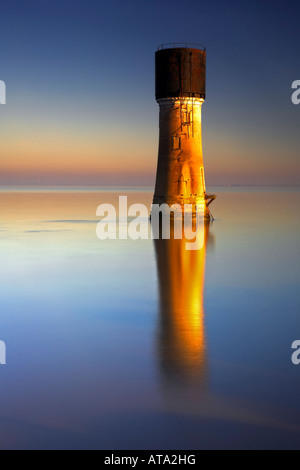 The Old Spurn Point Lighthouse and its reflection in the Humber Estuary on the Holderness Coast Humberside East Yorkshire UK Stock Photo