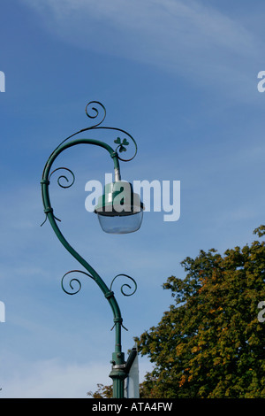 Green ornamental street lamp with shamrock emblem Stock Photo