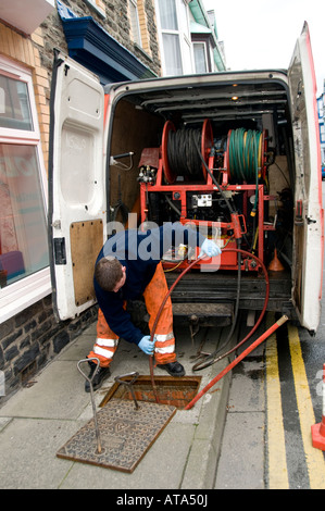 Dyno rod worker drain clearing blocked drain outside a terraced house ...
