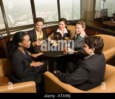 Ethnically diverse businesspeople sitting at table in restaurant talking Stock Photo