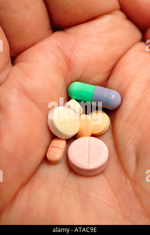 MIXTURE OF PILLS IN PALM OF HAND Stock Photo