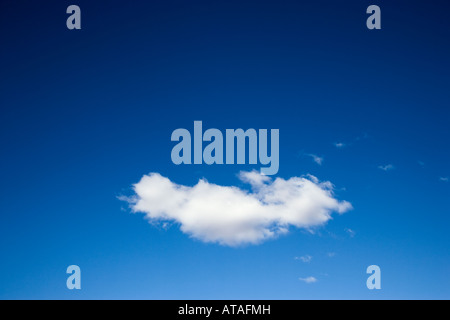Single white fluffy cloud in blue sky Stock Photo