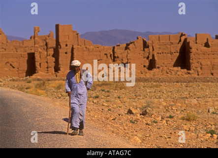 1, one, Moroccan man, Berber man, walking along road, between Agdz and Zagora, Draa Valley, Draa River Valley, Morocco, Africa Stock Photo