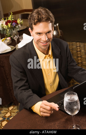 High angle view of Caucasian businessman with laptop in restaurant Stock Photo