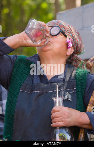 Old lady drinking wine at winemaking show at Lipica stud farm Slovenia Stock Photo