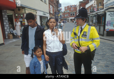 A policeman gives directions to a young foreign family in Windsor on the day of the royal wedding , June 1999 Stock Photo