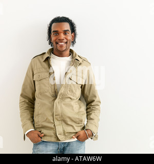 Portrait of smiling man standing against white background Stock Photo