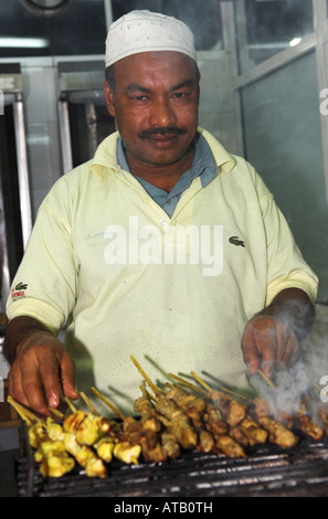 Portrait Indian man cooking kebabs in Oman Stock Photo
