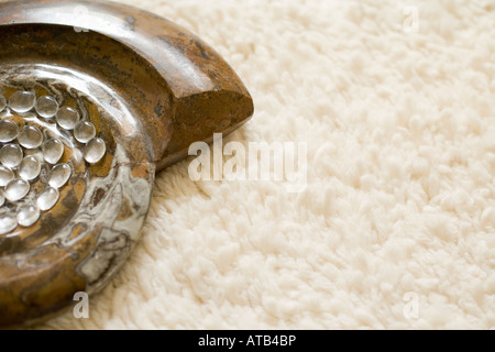 a part of a decorative marble artwork in the shape of a spiral on a soft fabric Stock Photo