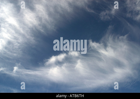 wispy cirrus marestail clouds move across the blue sky Stock Photo