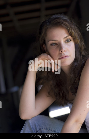 cute dark-haired women with green eyes her head resting on hand Stock Photo