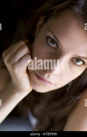portrait of a nice dark-haired women with her head resting on hand Stock Photo
