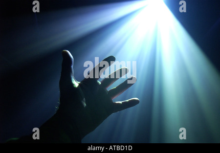 hand reaching out in a ray of light,  photo by Bruce Miller 2002 Stock Photo