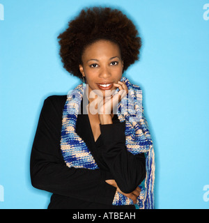 Pretty woman smiling against blue background Stock Photo