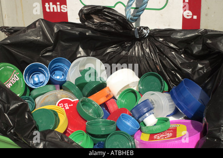 plastic jar & bottle caps in recycling bin Stock Photo