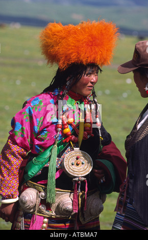 Khampa nomad woman in traditional clothes at Litang horse festival. Sichuan, China Stock Photo