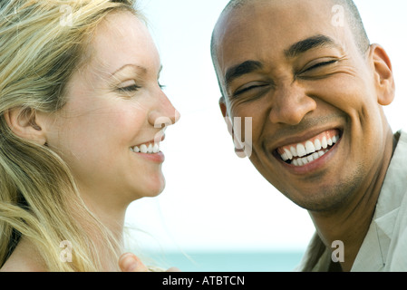 Couple laughing together, man looking at camera, close-up Stock Photo