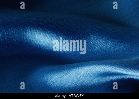 Folds in blue fabric, close-up Stock Photo