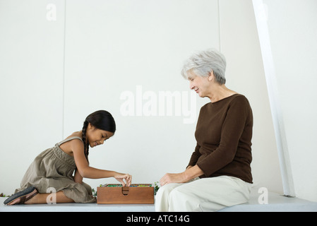 Girl and grandmother playing game together Stock Photo