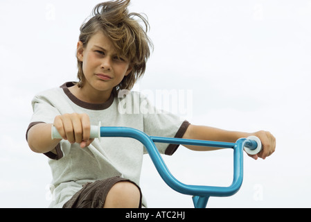 Boy on bicycle, looking at camera, portrait Stock Photo