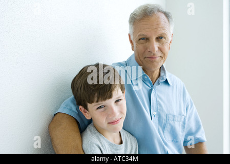 Grandfather and grandson smiling at camera together, portrait Stock Photo