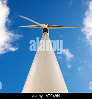 Perspective shot of wind turbine against blue sky Stock Photo