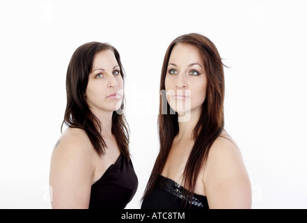 twin sisters in evening dresses Stock Photo