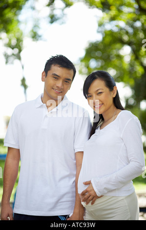 husband and pregnant wife in the park Stock Photo