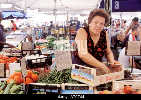 A stallholder arranging her vegetables in the Campo de' Fiori market Stock Photo