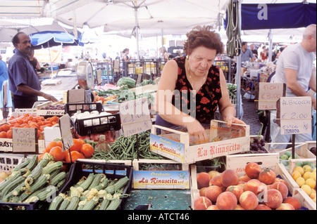 A stallholder arranging her vegetables in the Campo de' Fiori market, held in one of Rome's most appealing squares. Stock Photo