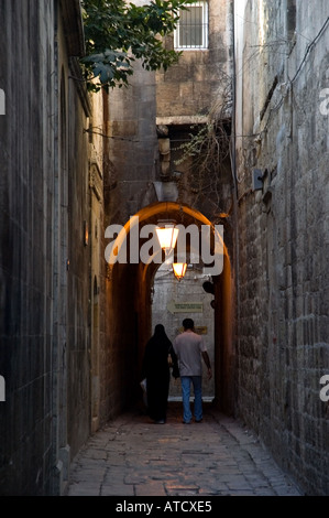 Two people in Narrow lane, street light, archway, in Jedeideh Quarter old city of Halab, Aleppo, Syria, Middle East. DSC 6266 Stock Photo