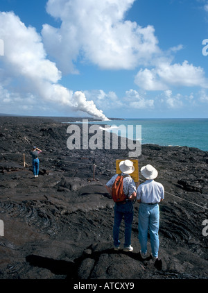 Couple looking at the steam from active lava flow, Volcanoes National Park, Big Island, Hawaii, USA Stock Photo