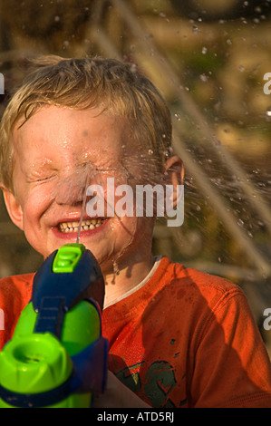 boy squirting face with water Stock Photo - Alamy