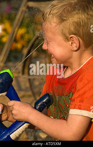 boy squirting face with water Stock Photo - Alamy
