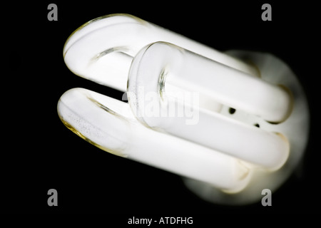 An energy saving light bulb with the light turned on Stock Photo