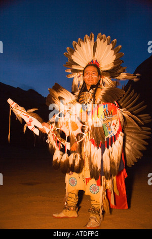 Native American powwow dancer in full traditional regalia at dusk Gallup Inter Tribal Indian Ceremonial Callup New Mexico Stock Photo