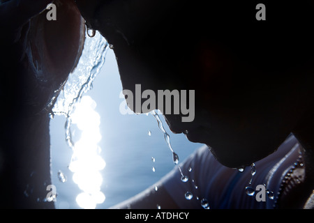 Silhouette of young woman splashing water Stock Photo