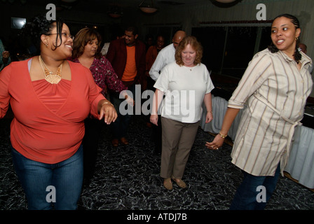 people having fun dancing the electric slide Stock Photo