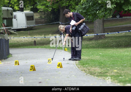 Scene of crime team examines the evidence UK Stock Photo